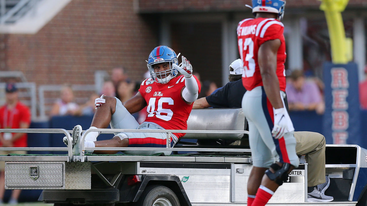 OXFORD, MISSISSIPPI - SEPTEMBER 07: MoMo Sanogo #46 of the Mississippi Rebels waves as he is carted off the field during the first half of a game against the Arkansas Razorbacks at Vaught-Hemingway Stadium on September 07, 2019 in Oxford, Mississippi.