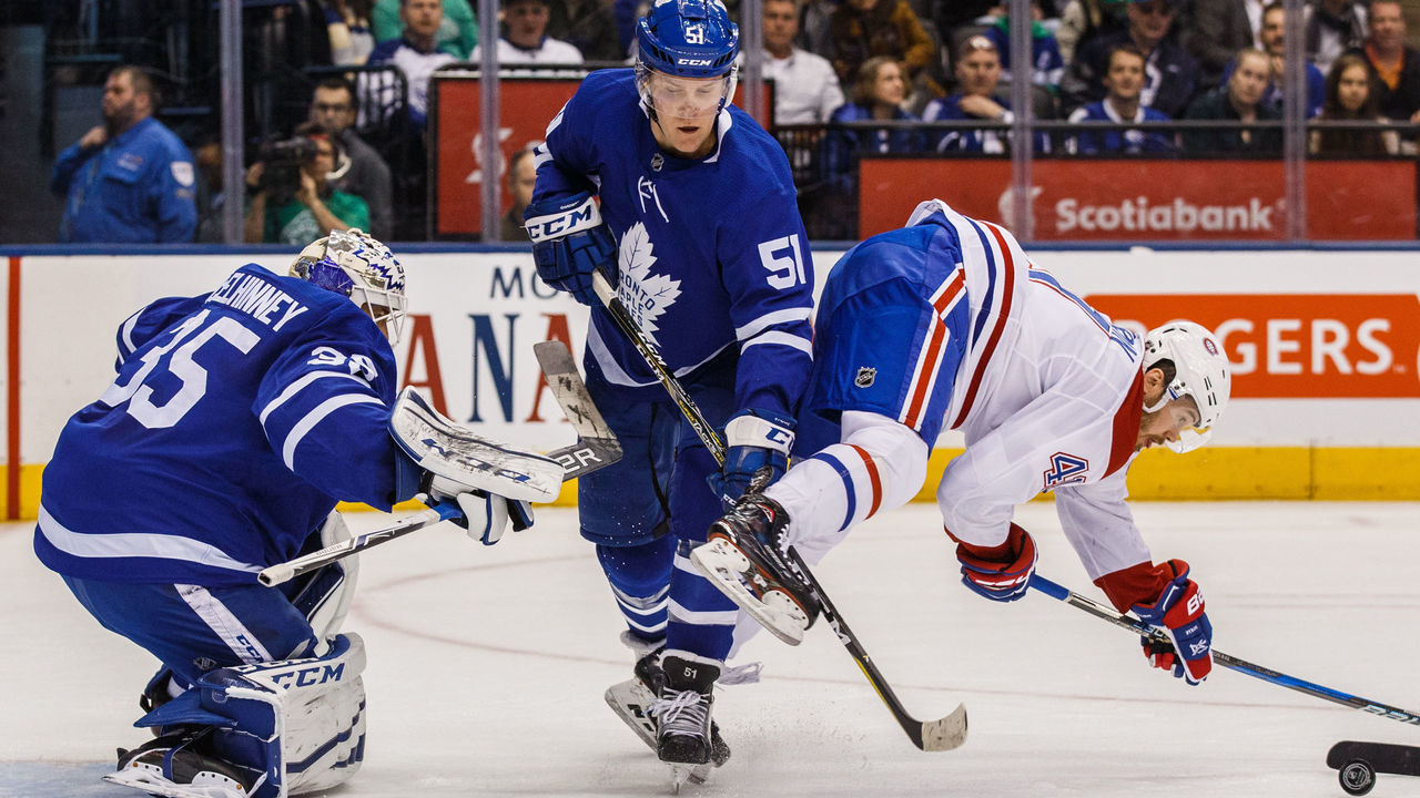 TORONTO, ON - MARCH 17: Jake Gardiner #51 of the Toronto Maple Leafs battles with Paul Byron #41 of the Montreal Canadiens in front of Curtis McElhinney #35 of the Toronto Maple Leafs during the first period at the Air Canada Centre on March 17, 2018 in Toronto, Ontario, Canada.
