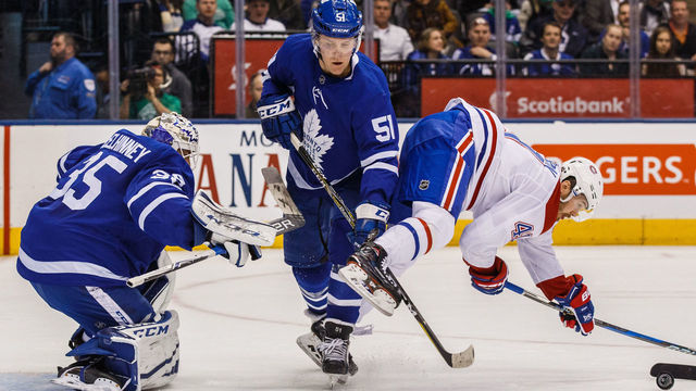 TORONTO, ON - MARCH 17: Jake Gardiner #51 of the Toronto Maple Leafs battles with Paul Byron #41 of the Montreal Canadiens in front of Curtis McElhinney #35 of the Toronto Maple Leafs during the first period at the Air Canada Centre on March 17, 2018 in Toronto, Ontario, Canada.