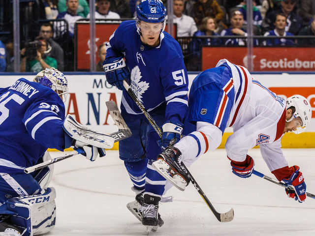 TORONTO, ON - MARCH 17: Jake Gardiner #51 of the Toronto Maple Leafs battles with Paul Byron #41 of the Montreal Canadiens in front of Curtis McElhinney #35 of the Toronto Maple Leafs during the first period at the Air Canada Centre on March 17, 2018 in Toronto, Ontario, Canada.