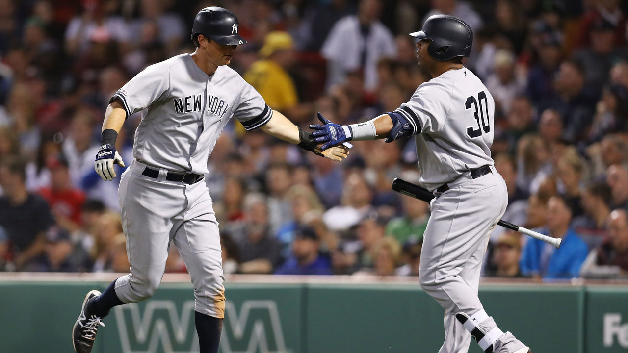 BOSTON, MASSACHUSETTS - SEPTEMBER 09: DJ LeMahieu #26 of the New York Yankees celebrates with Edwin Encarnacion #30 after scoring a run during the seventh inning of the game between the Boston Red Sox and the New York Yankees at Fenway Park on September 09, 2019 in Boston, Massachusetts.