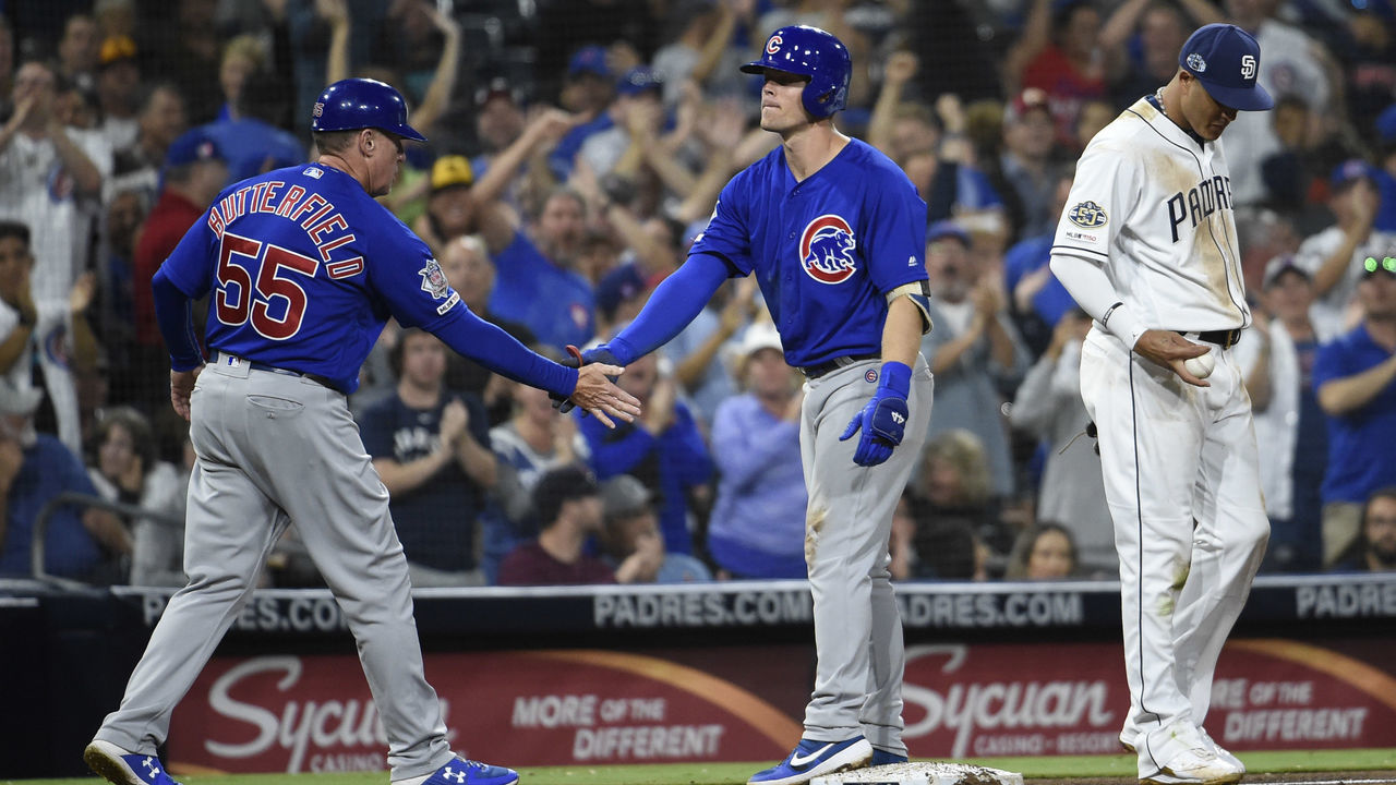 SAN DIEGO, CA - SEPTEMBER 9: Nico Hoerner #2 of the Chicago Cubs, center, is congratulated by Brian Butterfield #55 after hitting a triple as Manny Machado #13 of the San Diego Padres looks on during the fifth inning of a baseball game at Petco Park September 9, 2019 in San Diego, California.