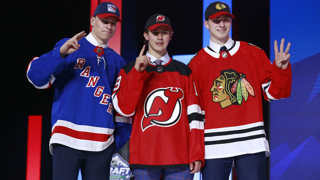 VANCOUVER, BRITISH COLUMBIA - JUNE 21: (L-R) Kaapo Kakko, second overall pick by the New York Rangers, Jack Hughes, first overall pick by the New Jersey Devils, and Kirby Dach, third overall pick by the Chicago Blackhawks, hold up their fingers of their pick order in front of the stage during the first round of the 2019 NHL Draft at Rogers Arena on June 21, 2019 in Vancouver, Canada.
