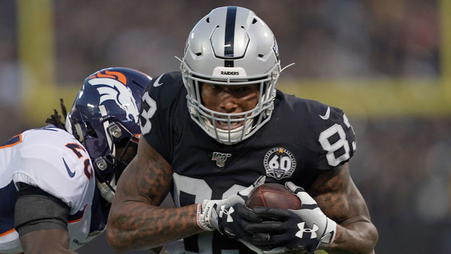 OAKLAND, CA - SEPTEMBER 09: Tight end Darren Waller #83 of the Oakland Raiders tries to avoid the tackle of cornerback Isaac Yiadom #26 of the Denver Broncos in the first quarter of the game at RingCentral Coliseum on September 9, 2019 in Oakland, California.