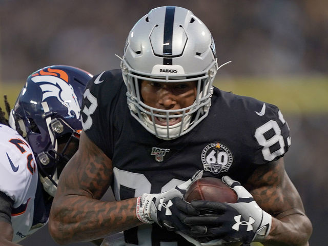 OAKLAND, CA - SEPTEMBER 09: Tight end Darren Waller #83 of the Oakland Raiders tries to avoid the tackle of cornerback Isaac Yiadom #26 of the Denver Broncos in the first quarter of the game at RingCentral Coliseum on September 9, 2019 in Oakland, California.