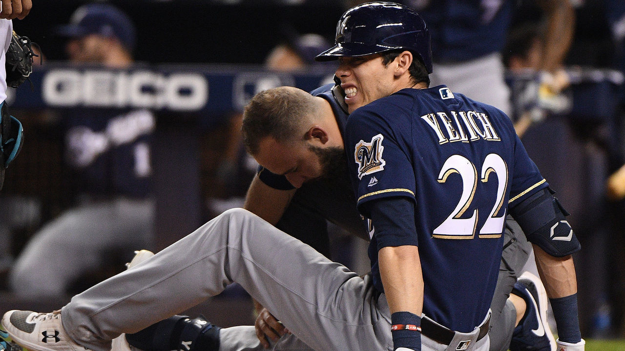 MIAMI, FLORIDA - SEPTEMBER 10: Christian Yelich #22 of the Milwaukee Brewers is checked out by the medical staff after an injury from ball deflection in the first inning against the Miami Marlins at Marlins Park on September 10, 2019 in Miami, Florida.