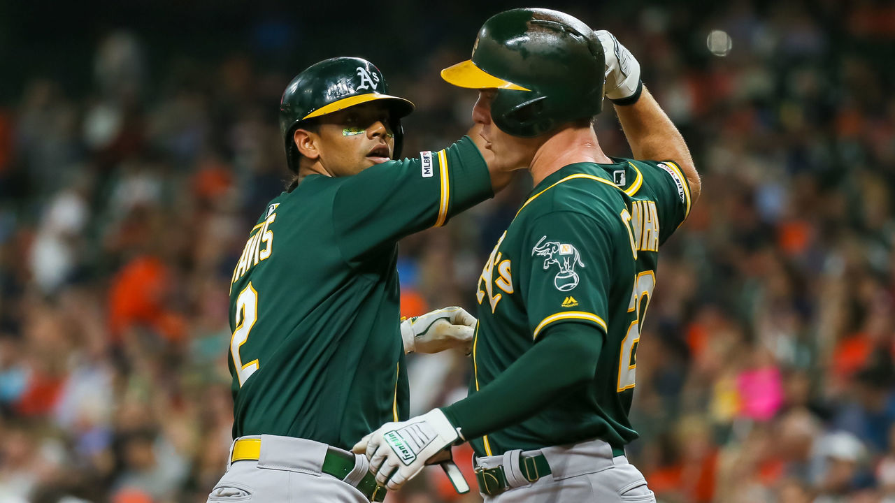 HOUSTON, TX - SEPTEMBER 10: Oakland Athletics designated hitter Khris Davis (2) hits a home run and Oakland Athletics center fielder Mark Canha (20) scores in the top of the second inning during the baseball game between the Oakland Athletics and Houston Astros at Minute Maid Park on September 10, 2019 in Houston, Texas.