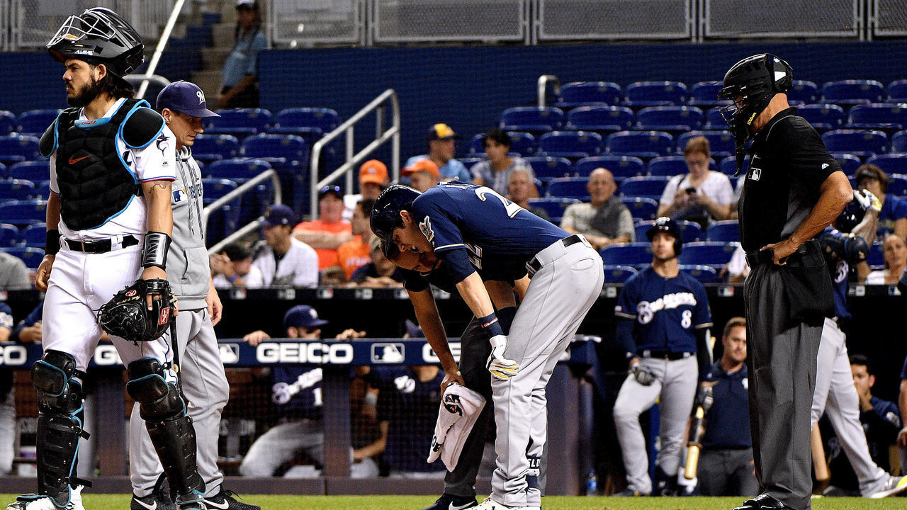MIAMI, FLORIDA - SEPTEMBER 10: Christian Yelich #22 of the Milwaukee Brewers is checked out by the medical staff after an injury from ball deflection in the first inning against the Miami Marlins at Marlins Park on September 10, 2019 in Miami, Florida.