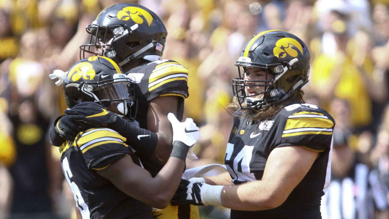 IOWA CITY, IOWA - SEPTEMBER 07: Wide receiver Ihmir Smith-Marsette #6 celebrates a touchdown with running back Tyler Goodsen #15 and offensive lineman Kyler Schott #64 of the Iowa Hawkeyes during the second half against the Rutgers Scarlet Knights on September 7, 2019 at Kinnick Stadium in Iowa City, Iowa.