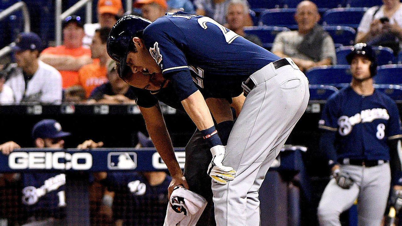 MIAMI, FLORIDA - SEPTEMBER 10: Christian Yelich #22 of the Milwaukee Brewers is checked out by the medical staff after an injury from ball deflection in the first inning against the Miami Marlins at Marlins Park on September 10, 2019 in Miami, Florida.