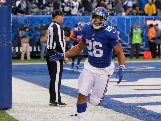 EAST RUTHERFORD, NJ - DECEMBER 30: (NEW YORK DAILIES OUT) Saquon Barkley #26 of the New York Giants celebrates a touchdown against the Dallas Cowboys on December 30, 2018 at MetLife Stadium in East Rutherford, New Jersey. The Cowboys defeated the Giants 36-35.