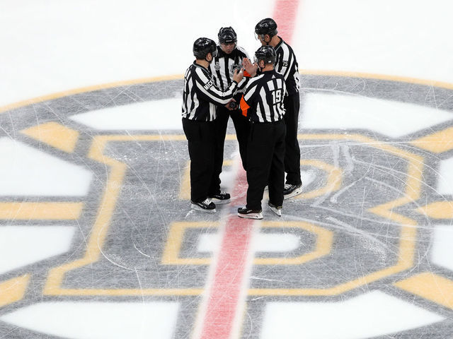 BOSTON, MASSACHUSETTS - JUNE 12: The referees meet at mid-ice prior to Game Seven of the 2019 NHL Stanley Cup Final between the Boston Bruins and the St. Louis Blues at TD Garden on June 12, 2019 in Boston, Massachusetts.