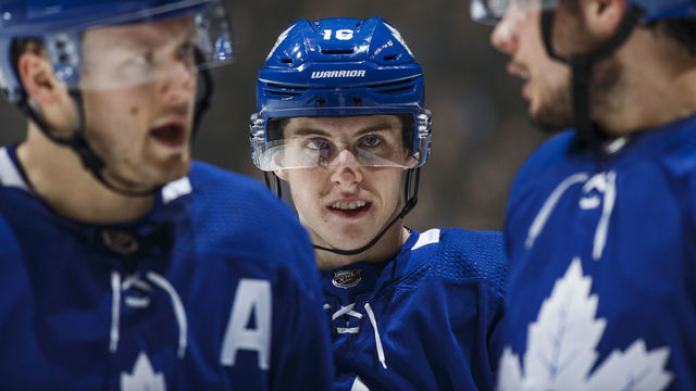 TORONTO, ON - FEBRUARY 2: Mitch Marner #16 of the Toronto Maple Leafs listens as teammates Morgan Rielly #44 and Auston Matthews #34 speak during the first period against the Pittsburgh Penguins at the Scotiabank Arena on February 2, 2019 in Toronto, Ontario, Canada.