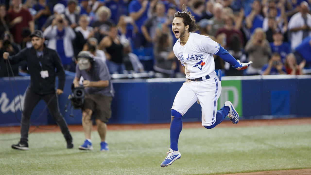 TORONTO, ON - SEPTEMBER 13: Bo Bichette #11 of the Toronto Blue Jays leaps as he runs into home plate, after hitting a home run to score the winning run in the twelfth inning of their MLB game against the New York Yankees at Rogers Centre on September 13, 2019 in Toronto, Canada.