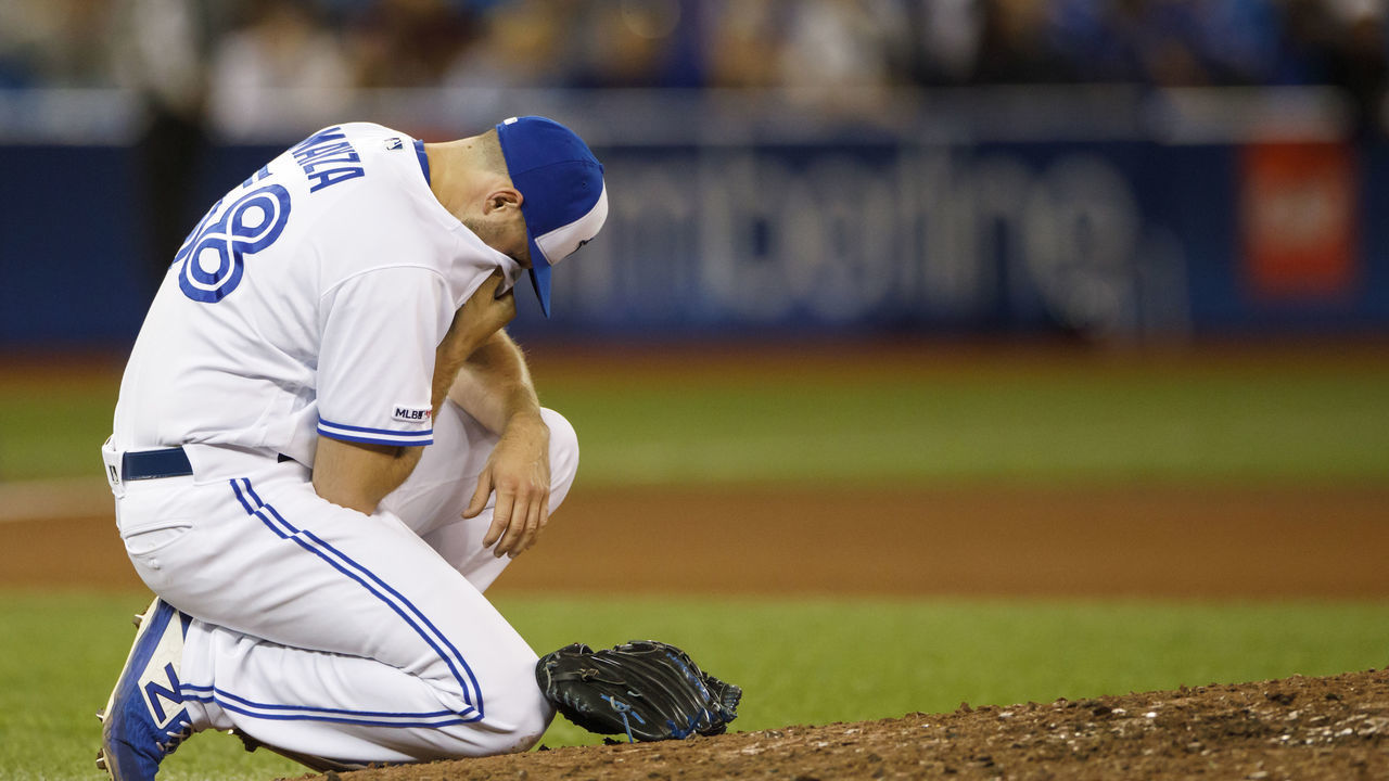 TORONTO, ON - SEPTEMBER 13: Tim Mayza #58 of the Toronto Blue Jays drops to his knees with an injury during tenth inning of their MLB game against the New York Yankees at Rogers Centre on September 13, 2019 in Toronto, Canada.