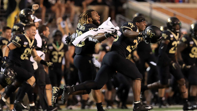 WINSTON SALEM, NORTH CAROLINA - SEPTEMBER 13: Christian Beal-Smith #26 of the Wake Forest Demon Deacons runs onto the field after defeating the North Carolina Tar Heels 24-18 at BB&T Field on September 13, 2019 in Winston Salem, North Carolina.