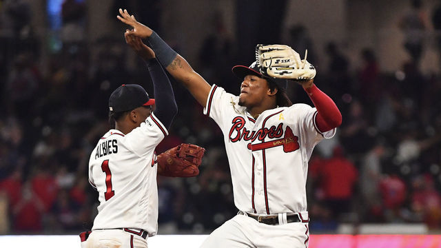 ATLANTA, GEORGIA - SEPTEMBER 07: Ozzie Albies #1 and Ronald Acuna Jr. #13 of the Atlanta Braves high five along with teammates Adeiny Hechavarria #24 and Billy Hamilton #9 after defeating the Washington Nationals at SunTrust Park on September 07, 2019 in Atlanta, Georgia.