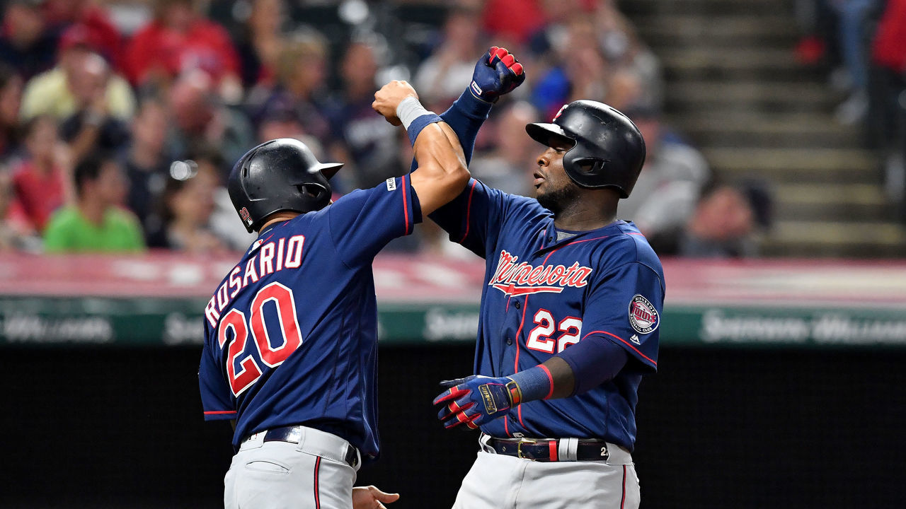 CLEVELAND, OHIO - SEPTEMBER 14: Eddie Rosario #20 celebrates with Miguel Sano #22 of the Minnesota Twins after both scored on a grand slam by Sano during the eighth inning of the second game of a double header against the Cleveland Indians at Progressive Field on September 14, 2019 in Cleveland, Ohio.