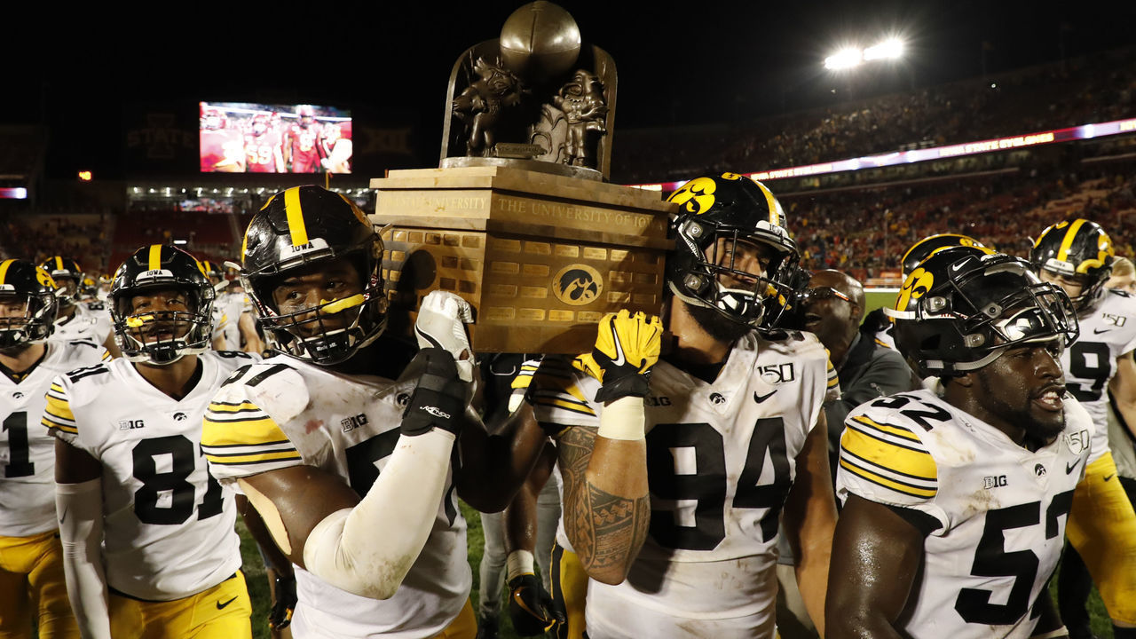 AMES, IA - SEPTEMBER 14: Defensive end Chauncey Golston #57, left, and defensive end A.J. Epenesa #94 of the Iowa Hawkeyes carry the Iowa Corn Cy-Hawk Trophy off the field after winning 18-17 over the Iowa State Cyclones at Jack Trice Stadium on September 14, 2019 in Ames, Iowa. The Iowa Hawkeyes won 18-17 over the Iowa State Cyclones.