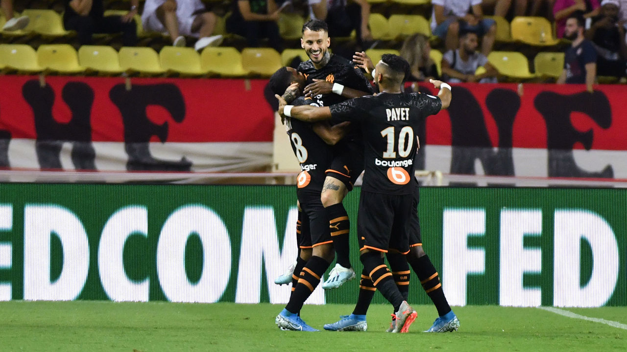 Olympique de Marseille's Argentine forward Dario Benedetto (C) celebrates with teammates after scoring a goal during the French L1 football match AS Monaco vs OM Marseille on September 15, 2019 at Louis II stadium in Monaco.