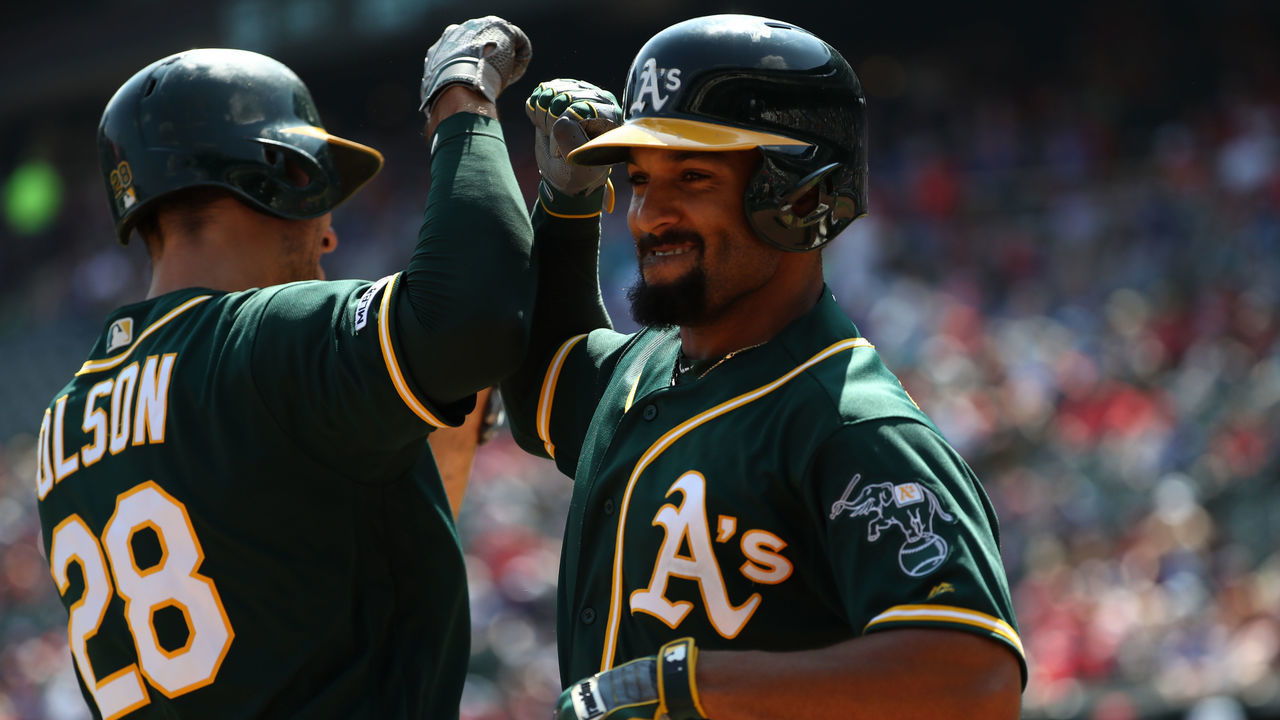 ARLINGTON, TEXAS - SEPTEMBER 15: Marcus Semien #10 of the Oakland Athletics celebrates a two-run homerun with Matt Olson #28 in the third inning against the Texas Rangers at Globe Life Park in Arlington on September 15, 2019 in Arlington, Texas.
