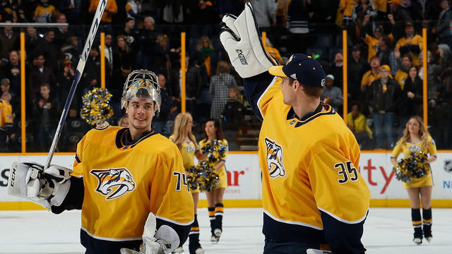 NASHVILLE, TN - DECEMBER 30: Pekka Rinne #35 congratulates Juuse Saros #74 of the Nashville Predators on his 3-0 shutout win against the Minnesota Wild during an NHL game at Bridgestone Arena on December 30, 2017 in Nashville, Tennessee.