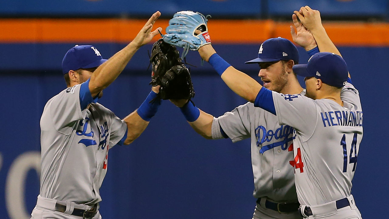 NEW YORK, NY - SEPTEMBER 15: Outfielders Chris Taylor #3, Cody Bellinger #35 and Enrique Hernandez #14 of the Los Angeles Dodgers congratulate each other after their 3-2 win over the New York Mets in a game at Citi Field on September 15, 2019 in New York City.