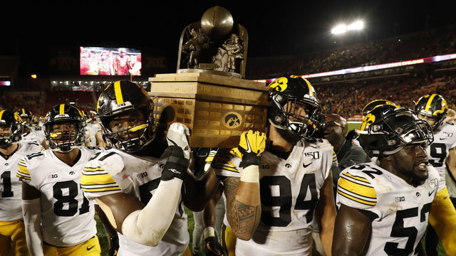 AMES, IA - SEPTEMBER 14: Defensive end Chauncey Golston #57, left, and defensive end A.J. Epenesa #94 of the Iowa Hawkeyes carry the Iowa Corn Cy-Hawk Trophy off the field after winning 18-17 over the Iowa State Cyclones at Jack Trice Stadium on September 14, 2019 in Ames, Iowa. The Iowa Hawkeyes won 18-17 over the Iowa State Cyclones.