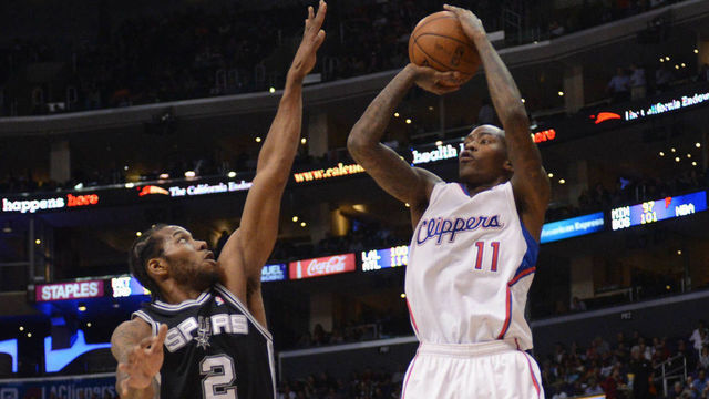 LOS ANGELES, CA - DECEMBER 16: Jamal Crawford #11 of the Los Angeles Clippers shoots against Kawhi Leonard #2 of the San Antonio Spurs at Staples Center on December 16, 2013 in Los Angeles, California. NOTE TO USER: User expressly acknowledges and agrees that, by downloading and/or using this Photograph, user is consenting to the terms and conditions of the Getty Images License Agreement. Mandatory Copyright Notice: Copyright 2013 NBAE