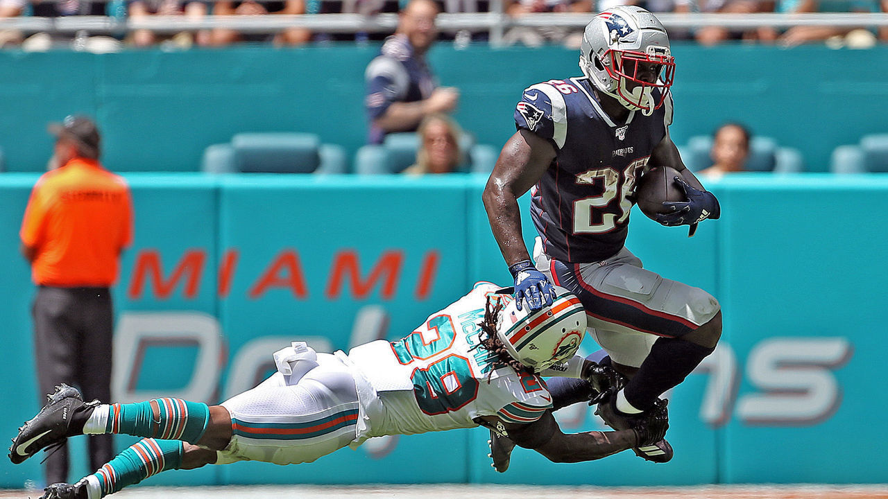 MIAMI , MA. - SEPTEMBER 15: Bobby McCain #28 of the Miami Dolphins dives for Sony Michel #26 of the New England Patriots legs during the second quarter of the NFL game at the Hard Rock Stadium on September 15, 2019 in Miami , Florida. (Staff Photo By Matt Stone/MediaNews Group/Boston Herald)