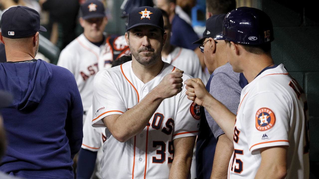 HOUSTON, TX - SEPTEMBER 12: Justin Verlander #35 of the Houston Astros is greeted by first base coach Don Kelly #15 as he leaves the game after the sixth inning against the Oakland Athletics at Minute Maid Park on September 12, 2019 in Houston, Texas.