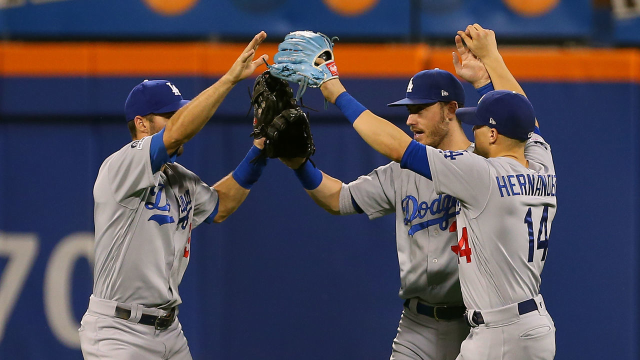 NEW YORK, NY - SEPTEMBER 15: Outfielders Chris Taylor #3, Cody Bellinger #35 and Enrique Hernandez #14 of the Los Angeles Dodgers congratulate each other after their 3-2 win over the New York Mets in a game at Citi Field on September 15, 2019 in New York City.