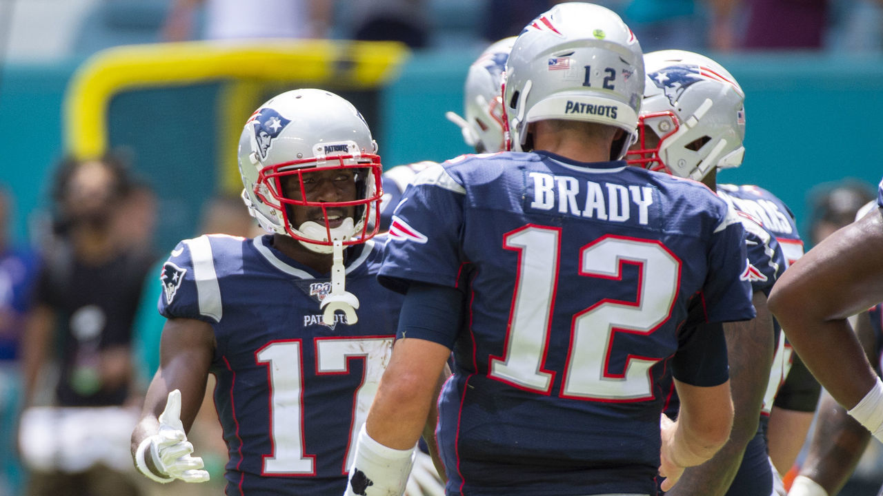 MIAMI GARDENS, FL - SEPTEMBER 15: New England Patriots Wide Receiver Antonio Brown (17) and New England Patriots Quarterback Tom Brady (12) talk on the field during the NFL game between the New England Patriots and the Miami Dolphins at the Hard Rock Stadium in Miami Gardens, Florida on September 15, 2019.
