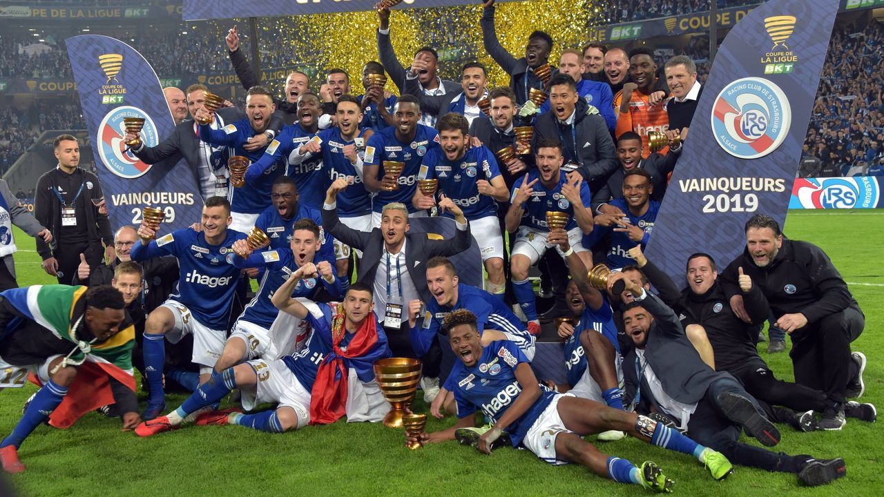Strasbourg players celebrate with the trophy at the end of the French League Cup final football match Guingamp vs Strasbourg, on March 30, 2019 at the Pierre-Mauroy stadium in Villeneuve d'Ascq.