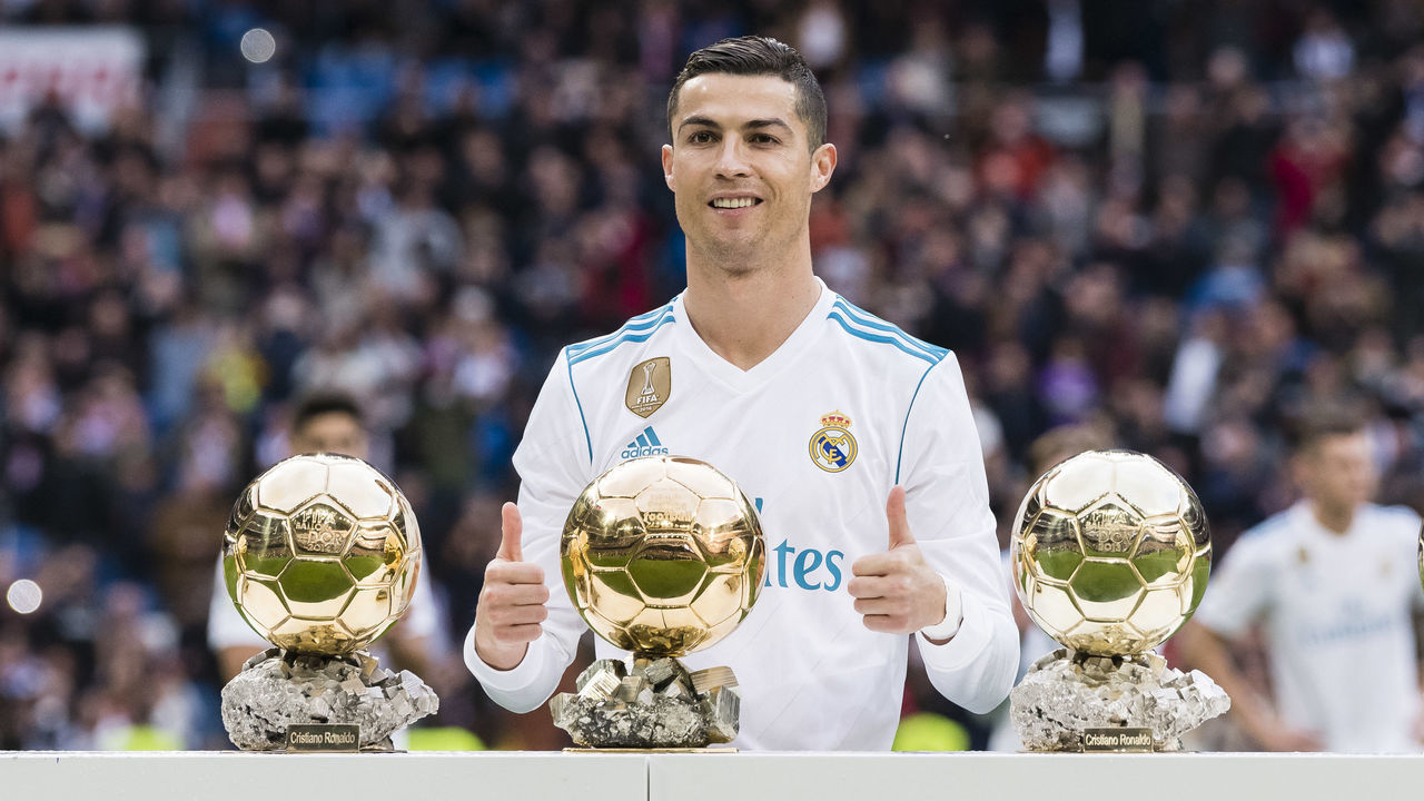 MADRID, SPAIN - DECEMBER 09: Cristiano Ronaldo of Real Madrid poses for photos with his FIFA Ballon Dor Trophies prior to the La Liga 2017-18 match between Real Madrid and Sevilla FC at Santiago Bernabeu Stadium on 09 December 2017 in Madrid, Spain.