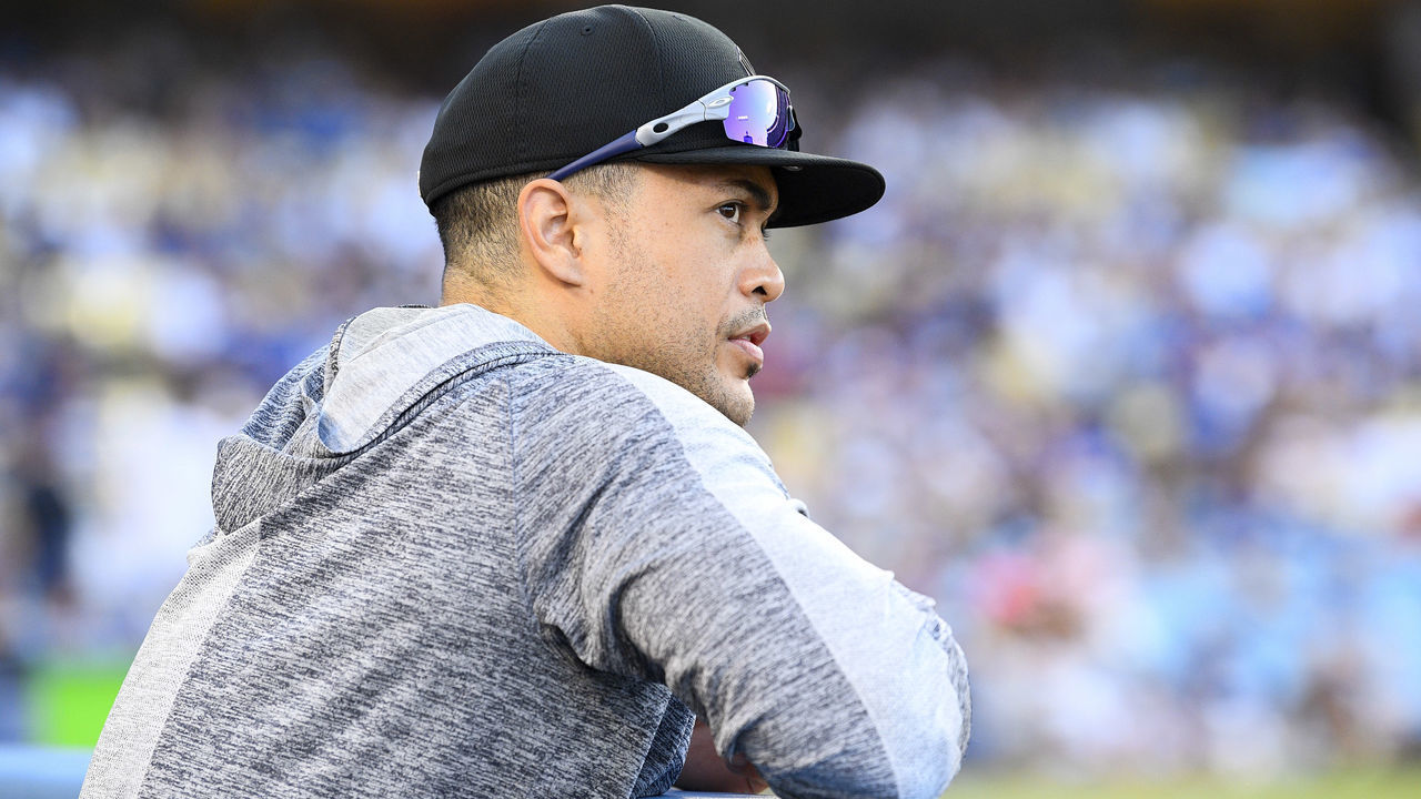 LOS ANGELES, CA - AUGUST 25: New York Yankees designated hitter Giancarlo Stanton (27) looks on from the dugout during a MLB game between the New York Yankees and the Los Angeles Dodgers on August 25, 2019 at Dodger Stadium in Los Angeles, CA.