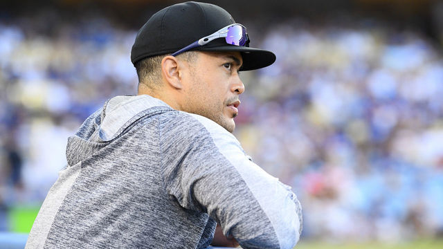 LOS ANGELES, CA - AUGUST 25: New York Yankees designated hitter Giancarlo Stanton (27) looks on from the dugout during a MLB game between the New York Yankees and the Los Angeles Dodgers on August 25, 2019 at Dodger Stadium in Los Angeles, CA.