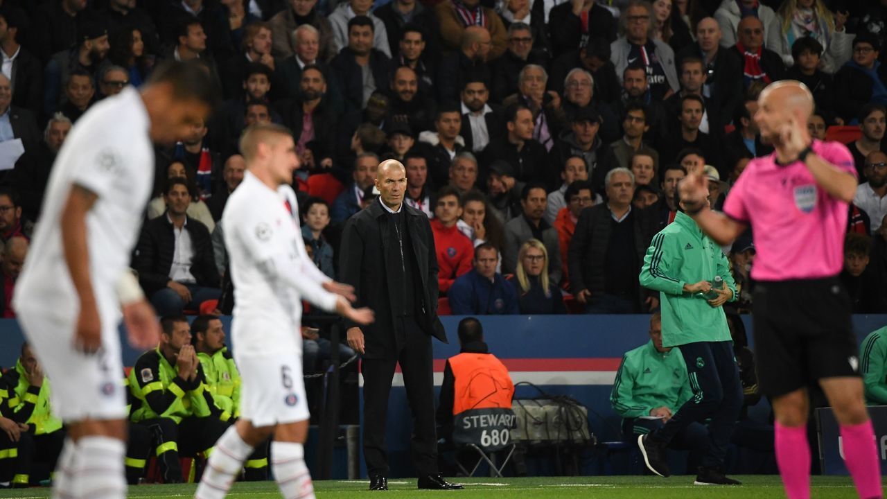 Real Madrid's French coach Zinedine Zidane (C) reacts while the goal by Real Madrid's Welsh forward Gareth Bale is been discussed during the UEFA Champions league Group A football match between Paris Saint-Germain and Real Madrid, at the Parc des Princes stadium, in Paris, on September 18, 2019.