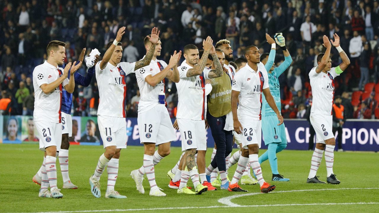 Paris Saint-Germain's team players celebrate with supporters after winning at the end of the UEFA Champions league Group A football match between Paris Saint-Germain and Real Madrid, at the Parc des Princes stadium, in Paris, on September 18, 2019.