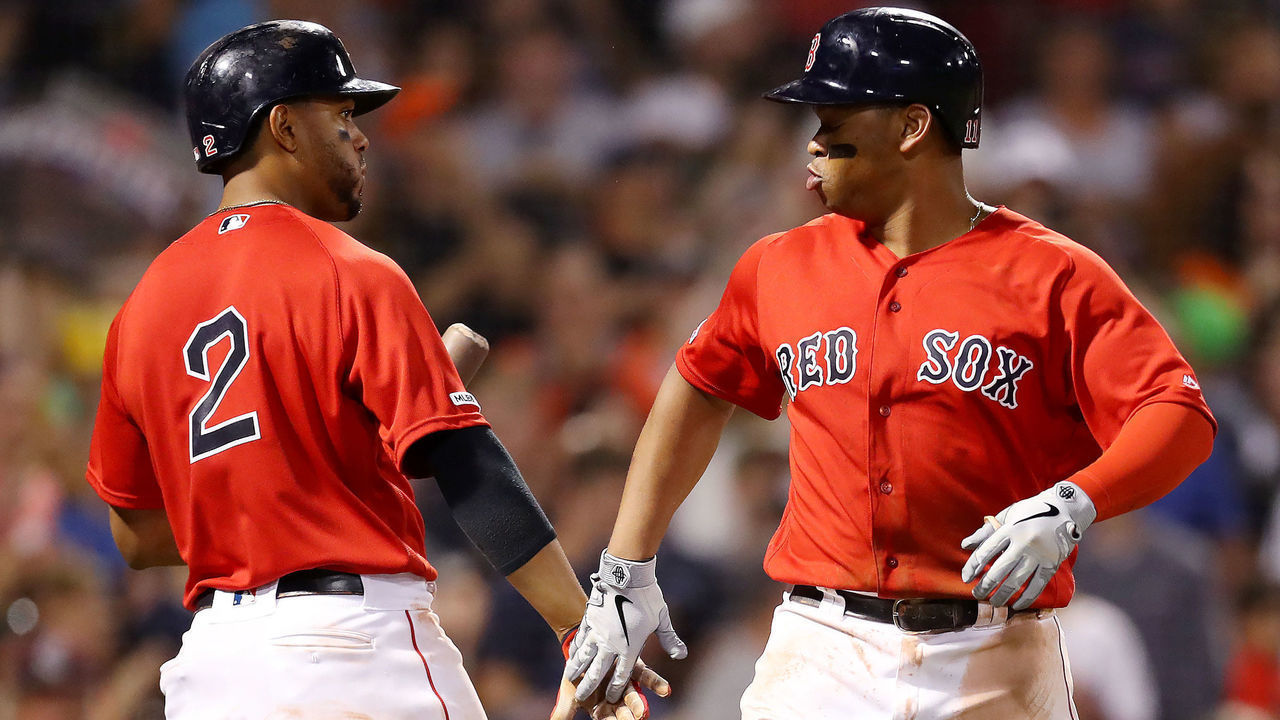 BOSTON, MASSACHUSETTS - AUGUST 17: Rafael Devers #11 of the Boston Red Sox celebrates with Xander Bogaerts #2 after hitting a home run against the Baltimore Orioles during the seventh inning at Fenway Park on August 17, 2019 in Boston, Massachusetts.
