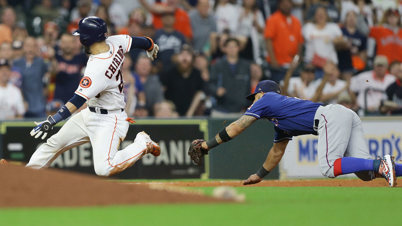 HOUSTON, TEXAS - SEPTEMBER 17: Robinson Chirinos #28 of the Houston Astros beats Rougned Odor #12 of the Texas Rangers to third base in the seventh inning at Minute Maid Park on September 17, 2019 in Houston, Texas.