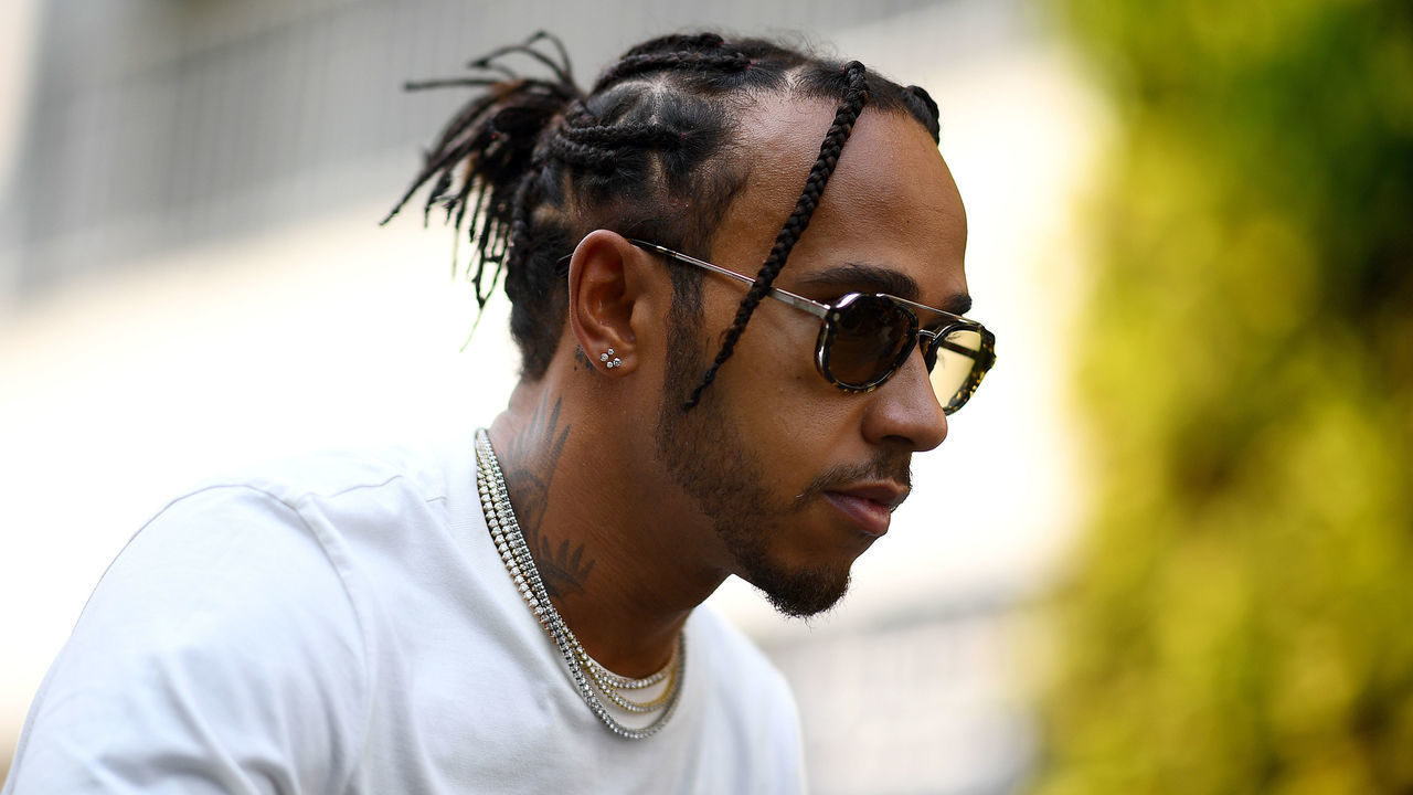 SINGAPORE, SINGAPORE - SEPTEMBER 19: Lewis Hamilton of Great Britain and Mercedes GP rides a scooter in the Paddock during previews ahead of the F1 Grand Prix of Singapore at Marina Bay Street Circuit on September 19, 2019 in Singapore.