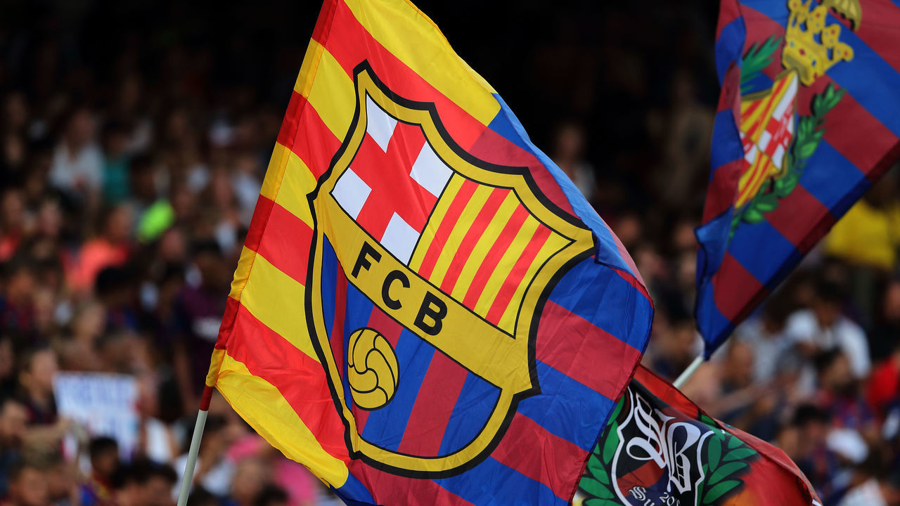 BARCELONA, SPAIN - AUGUST 04: Fans of FC Barcelona wave flags during the Pre-Season Friendly between FC Barcelona and Arsenal at Nou Camp on August 4, 2019 in Barcelona, Spain.