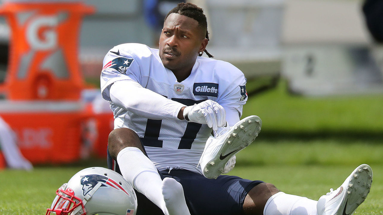 FOXBOROUGH, MA - SEPTEMBER 18: New England Patriots wide receiver Antonio Brown puts on his shoes on the field during New England Patriots practice at Gillette Stadium in Foxborough, MA on Sep. 18, 2019.