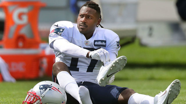 FOXBOROUGH, MA - SEPTEMBER 18: New England Patriots wide receiver Antonio Brown puts on his shoes on the field during New England Patriots practice at Gillette Stadium in Foxborough, MA on Sep. 18, 2019.