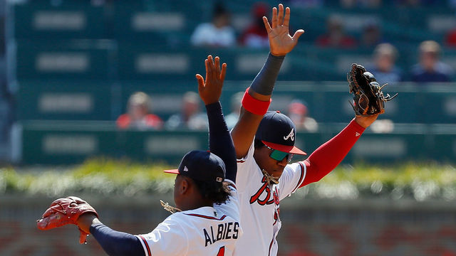ATLANTA, GEORGIA - SEPTEMBER 19: Ozzie Albies #1 and Ronald Acuna Jr. #13 of the Atlanta Braves celebrate after their 5-4 win over the Philadelphia Phillies at SunTrust Park on September 19, 2019 in Atlanta, Georgia.