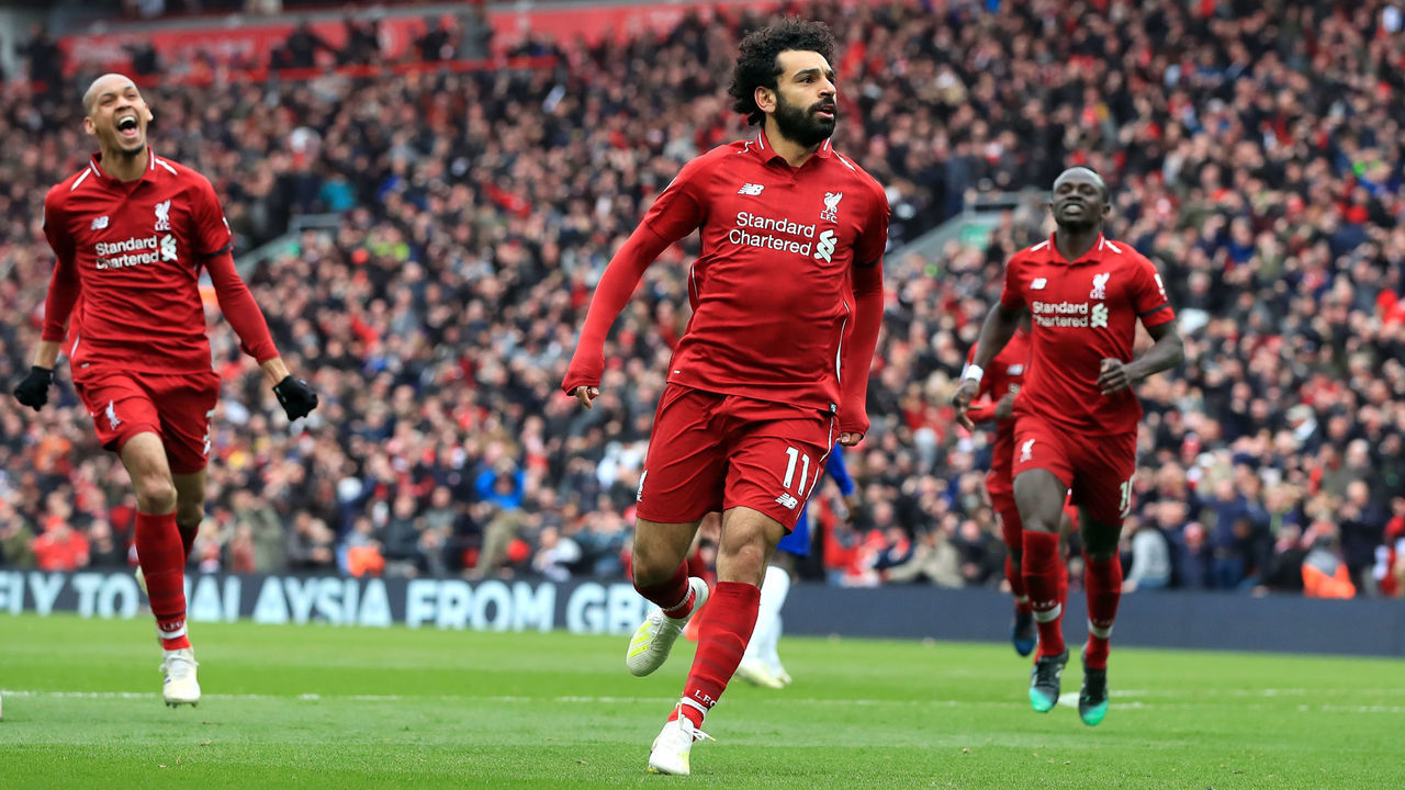 Liverpool's Mohamed Salah (centre) celebrates scoring his side's second goal of the game during the Premier League match at Anfield, Liverpool.