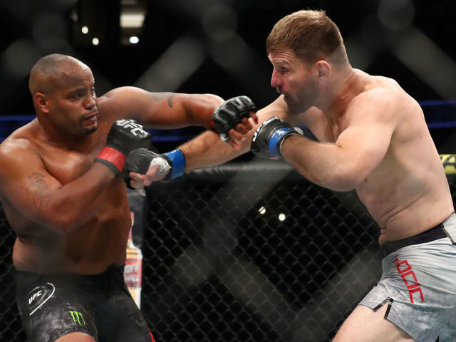 ANAHEIM, CALIFORNIA - AUGUST 17: Daniel Cormier throws a punch at Stipe Miocic in the first round during their UFC Heavyweight Title Bout at UFC 241 at Honda Center on August 17, 2019 in Anaheim, California.