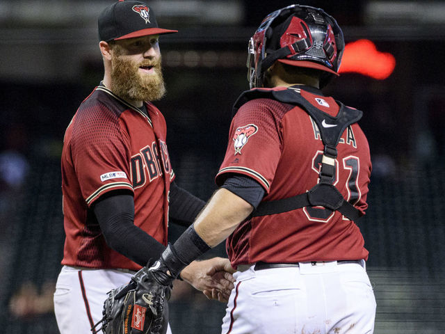 PHOENIX, ARIZONA - SEPTEMBER 18: Archie Bradley #25 and Alex Avila #31 of the Arizona Diamondbacks celebrate after closing out the MLB game against the Miami Marlins at Chase Field on September 18, 2019 in Phoenix, Arizona.