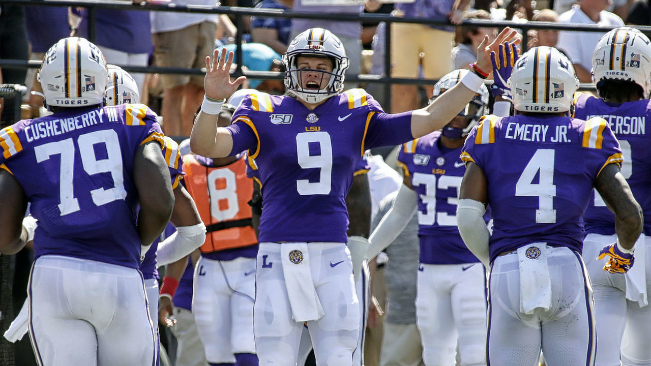 NASHVILLE, TENNESSEE - SEPTEMBER 21: Quarterback Joe Burrow #9 of the LSU Tigers high fives teammates after scoring against the Vanderbilt Commodores during the first half at Vanderbilt Stadium on September 21, 2019 in Nashville, Tennessee.